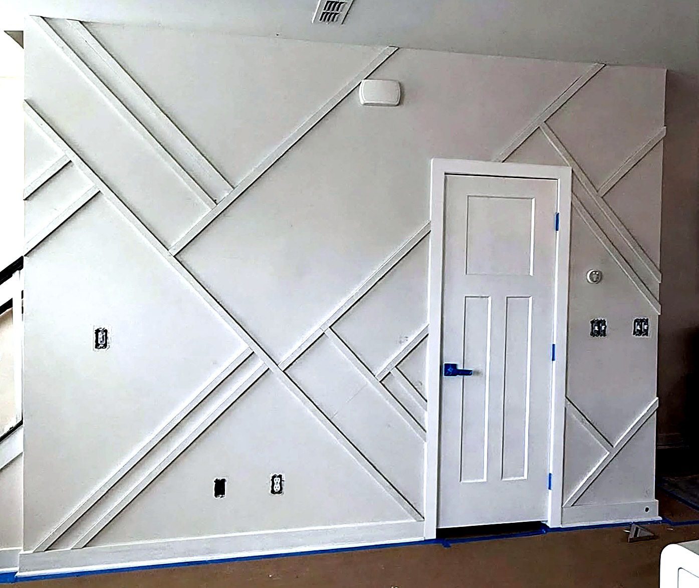 Custom geometric accent wall trim and drywall carpentry work by Verdeja Painting & Remodeling