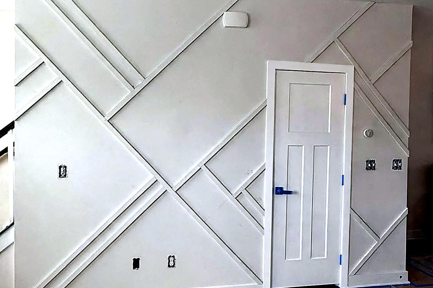 Custom geometric accent wall trim and drywall carpentry work by Verdeja Painting & Remodeling