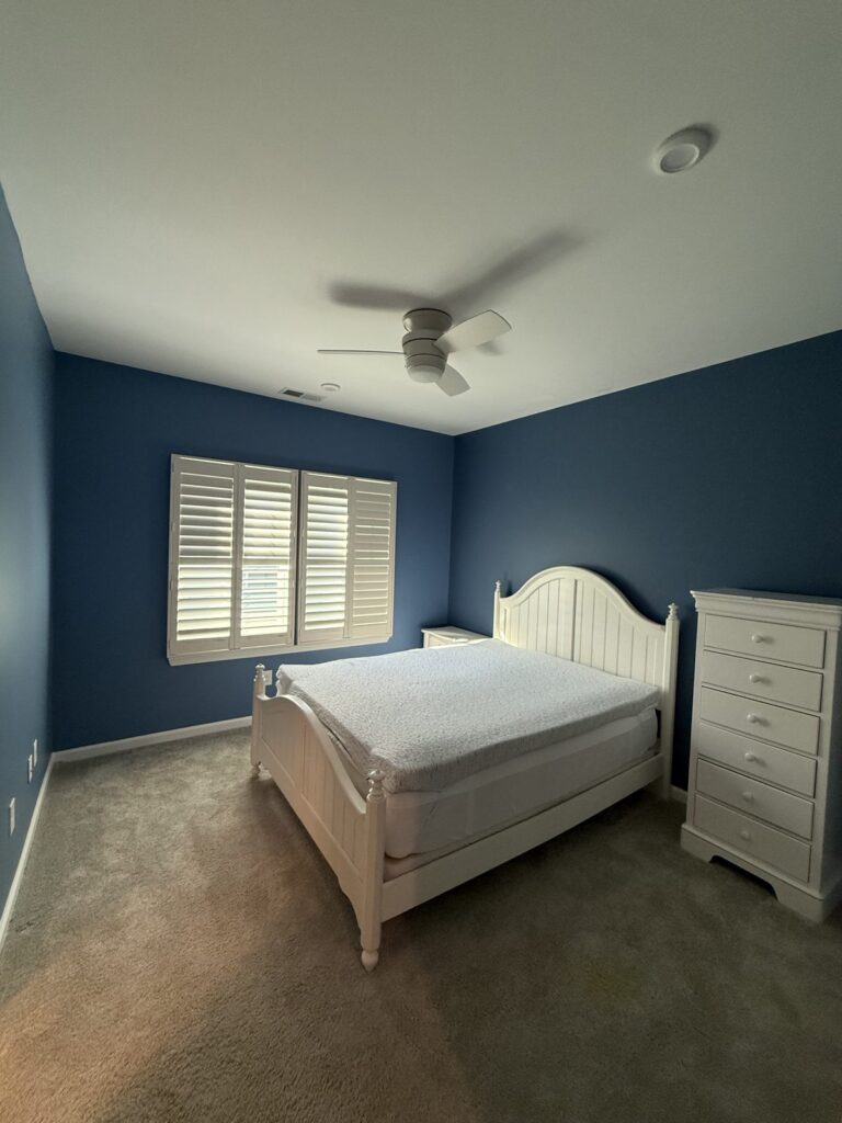 Bedroom painted a bold blue with white ceiling and trim by Verdeja Painting & Remodeling in Greenville, SC