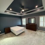 Master bedroom with navy painted tray ceiling and accent wall by Verdeja Painting & Remodeling in Greenville, SC