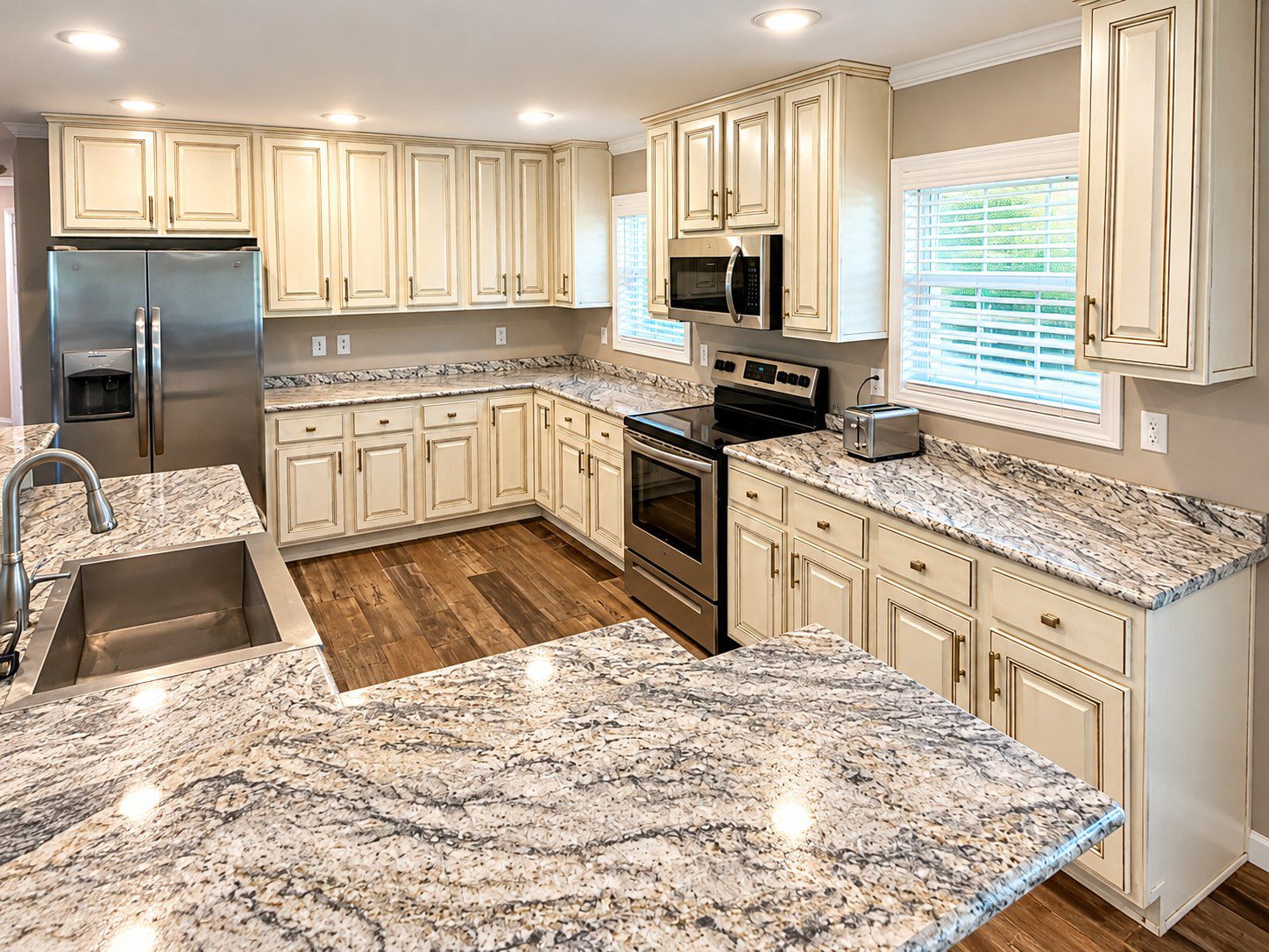 Kitchen cabinets painted cream with hand-applied glaze in Greenville, SC