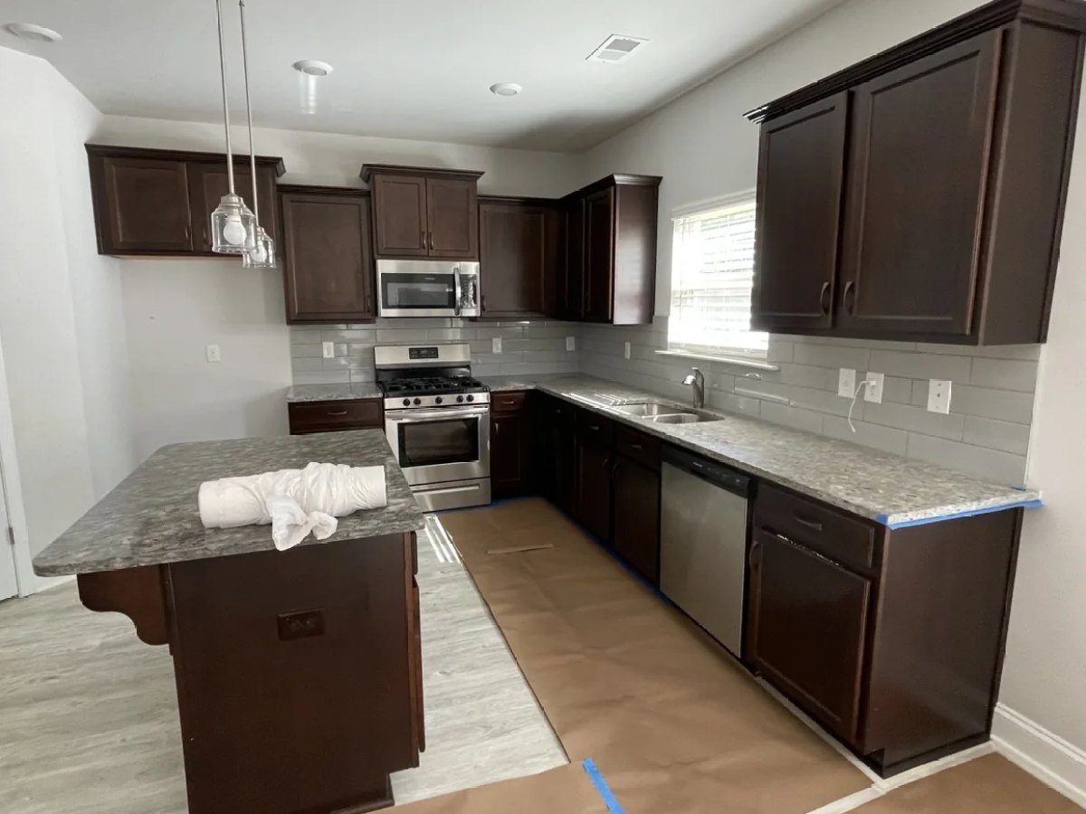 Espresso kitchen cabinets before painting in Greenville, SC