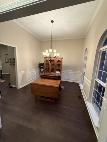Dining room in a Greer, SC home with painted walls, white wainscoting and crown molding