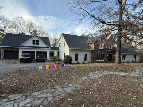 Two-story Greer, SC home with white siding and stone accents after exterior painting by Verdeja Painting & Remodeling