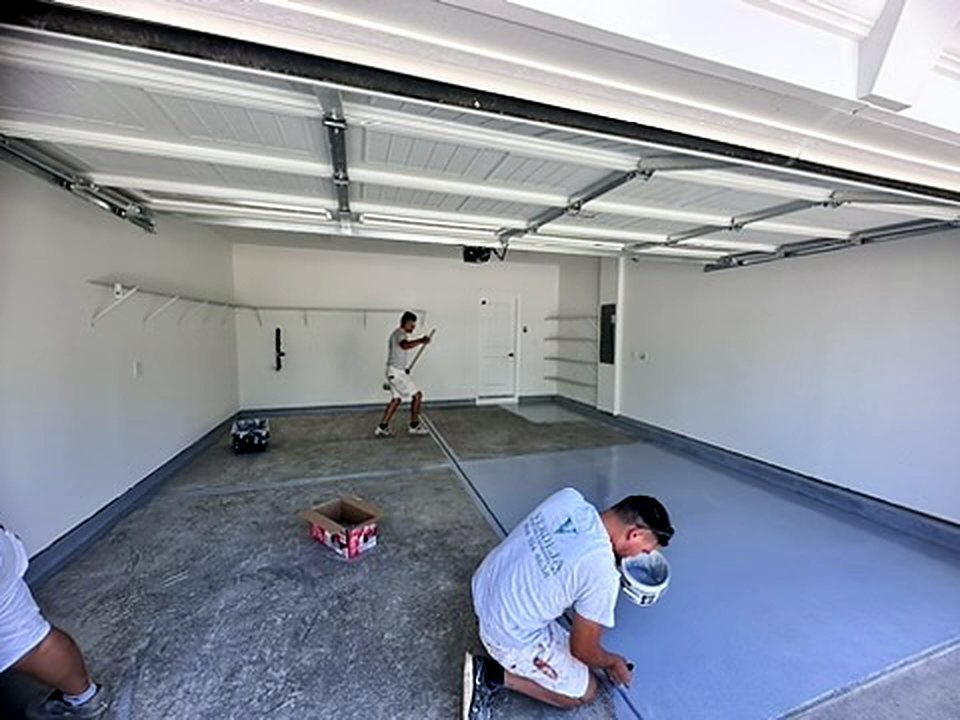 Verdeja Painting crew painting garage walls and a gray garage floor in Greenville SC