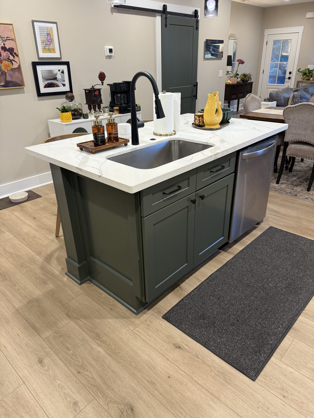 Kitchen island cabinets painted dark green with white quartz countertop, cabinet painting by Verdeja Painting