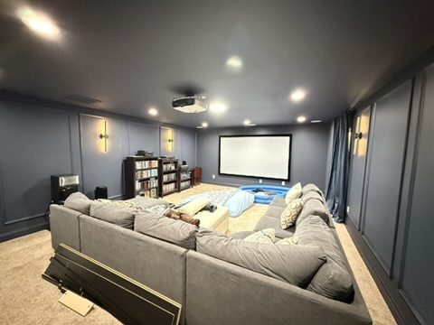 Home theater in Greer, SC painted a dark blue-gray with picture-frame wall panel molding