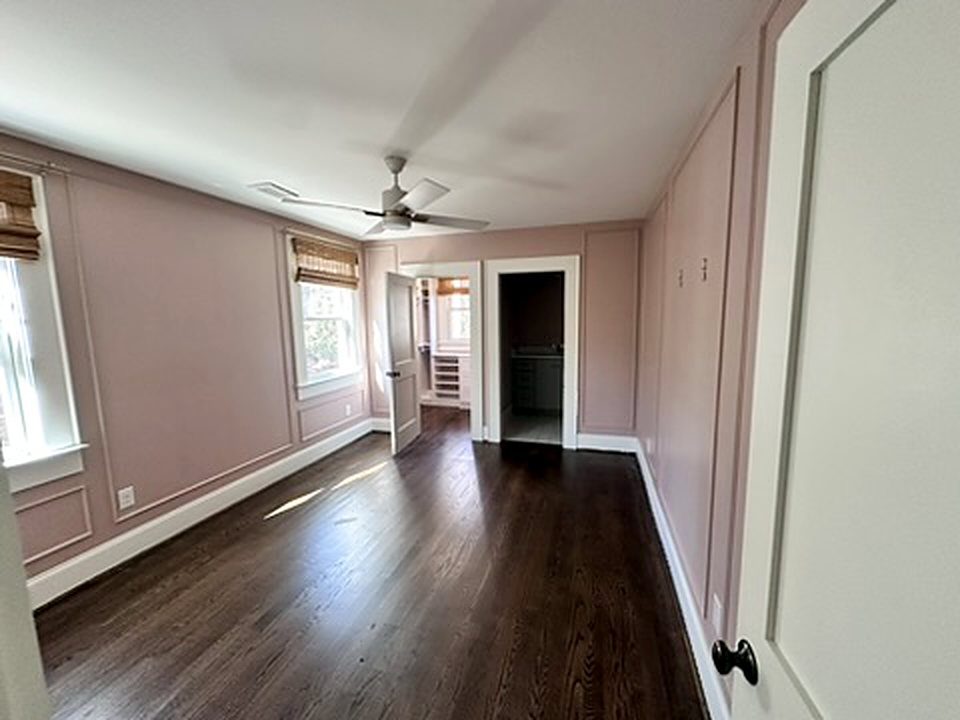 Bedroom painted soft mauve with picture-frame wall molding and white trim, interior painting in Greenville SC
