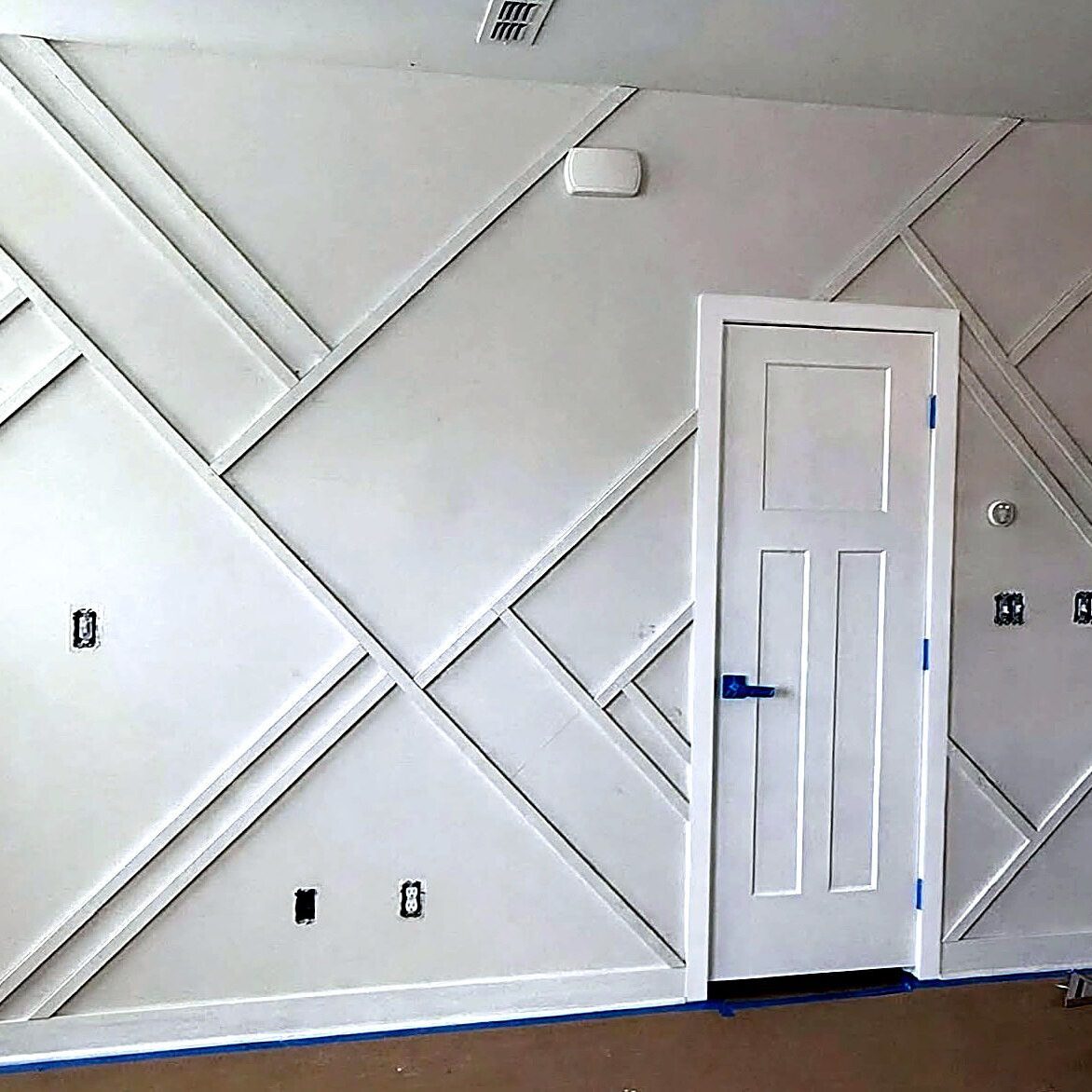 Custom geometric accent wall trim and drywall carpentry work by Verdeja Painting & Remodeling